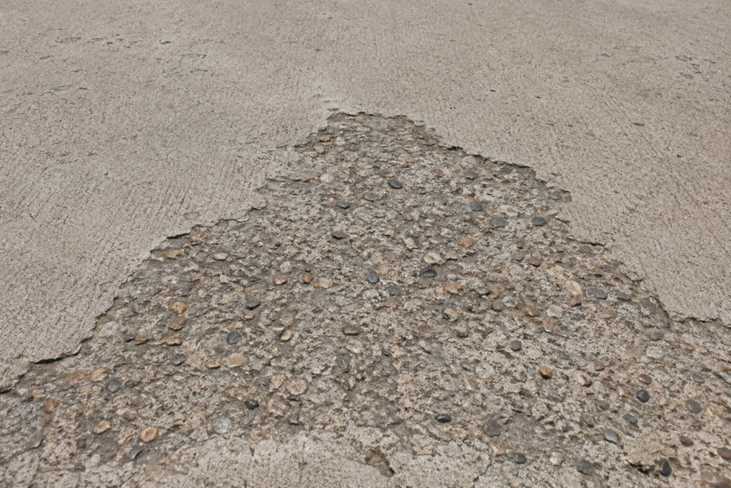 Washed out concrete surface showing aggregate exposure Washed out concrete surface showing aggregate exposure
